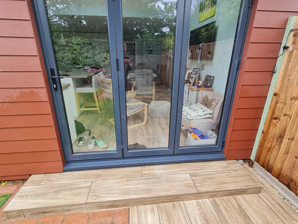 Wood-effect decking outside bi-fold doors